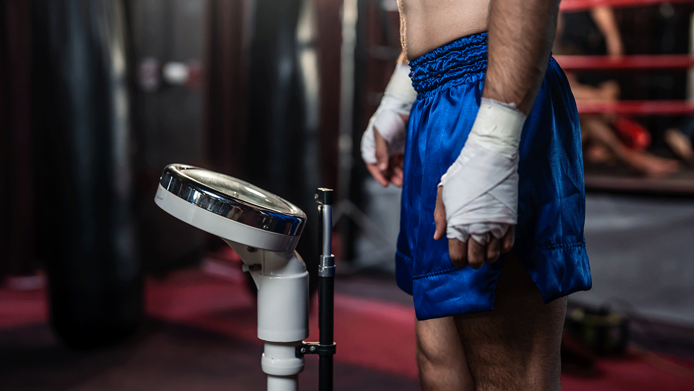 Close up of a male boxer standing on scales