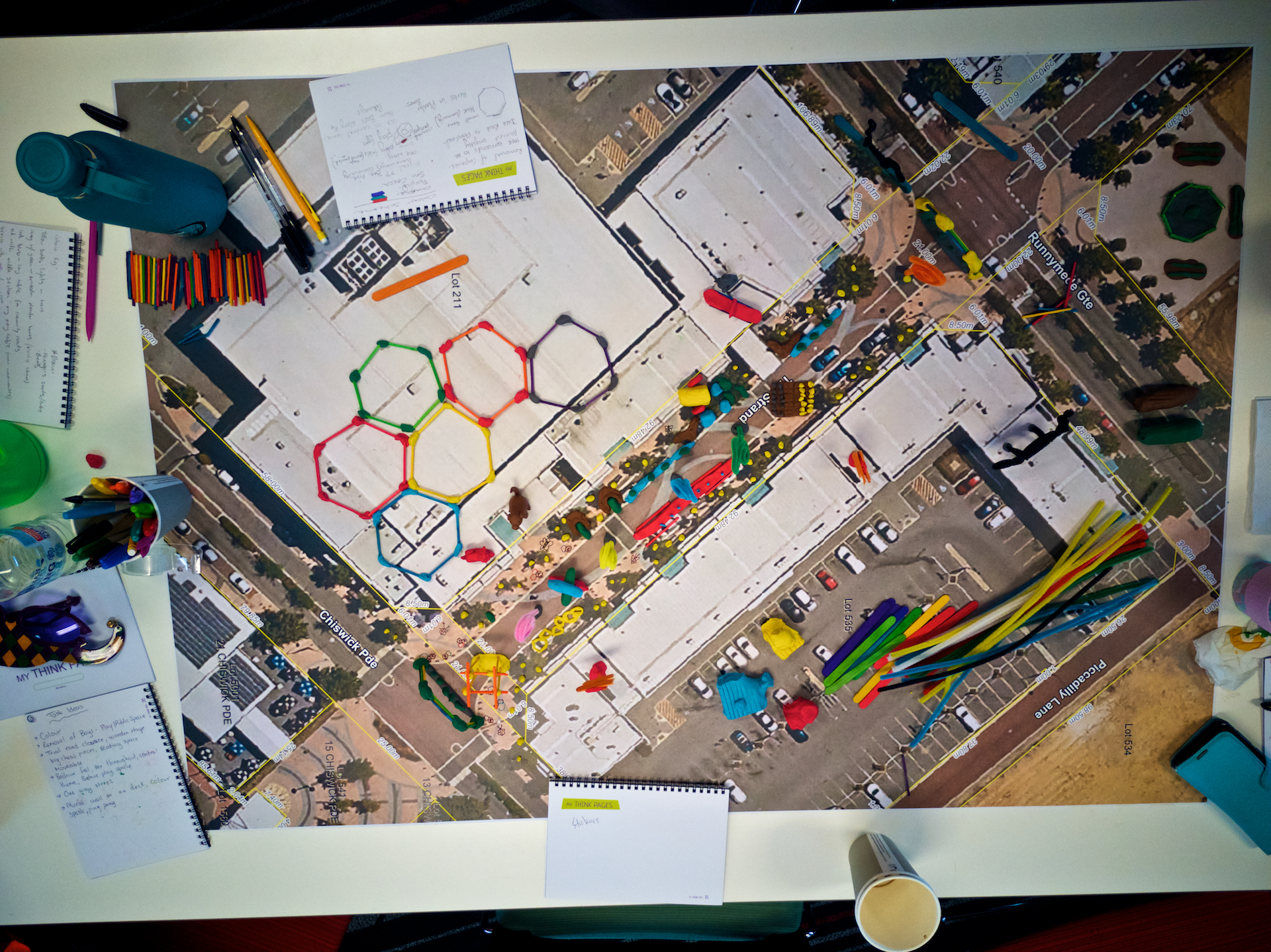 City of Kwinana - Wellard 7 day makeover project planning image showing pens, notebooks and large format map