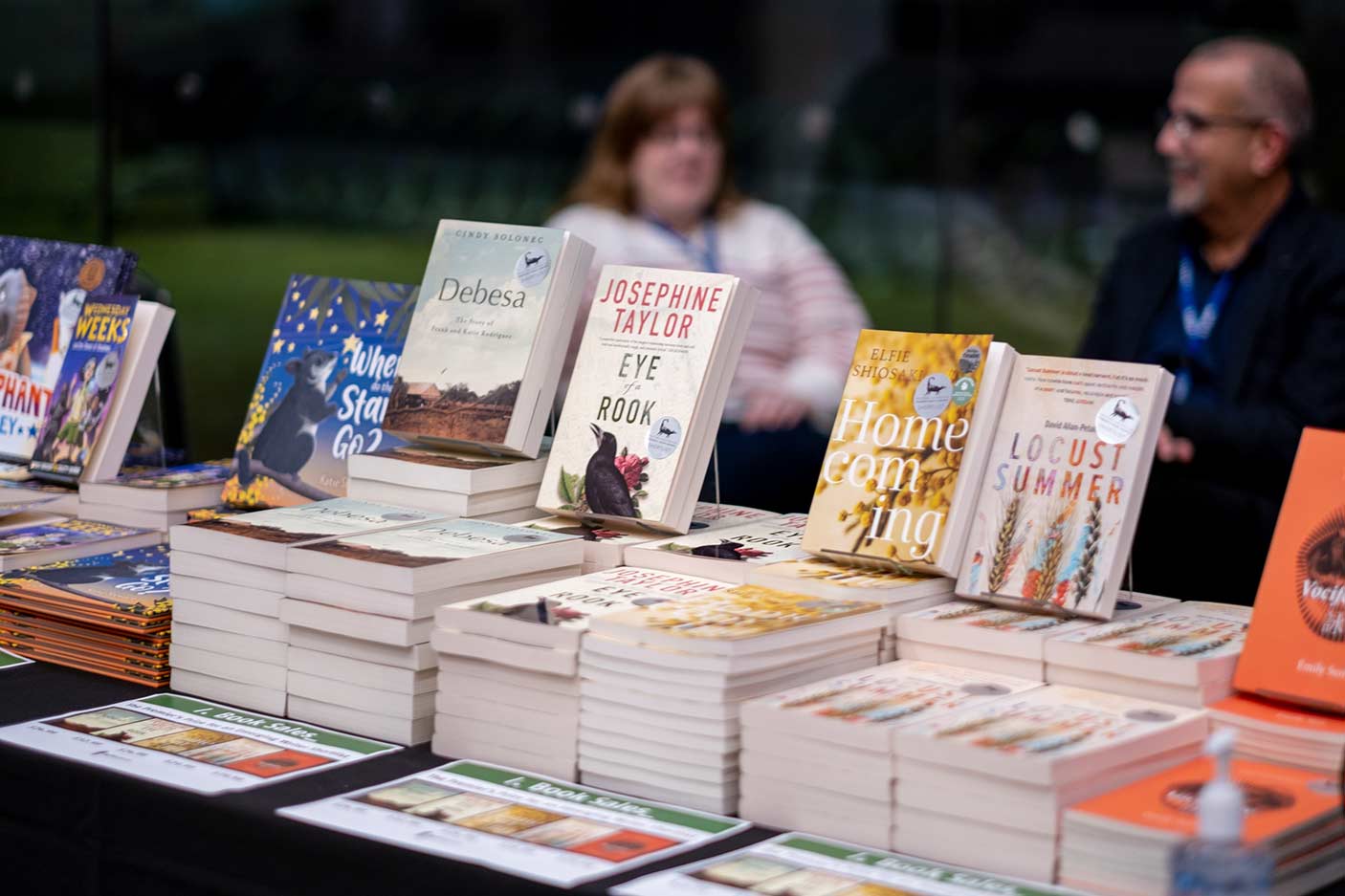 Various books stacked on a table for display