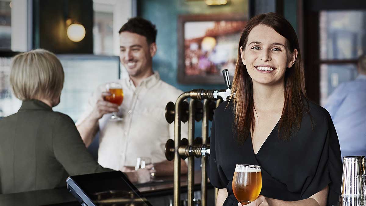 A bartender with patrons