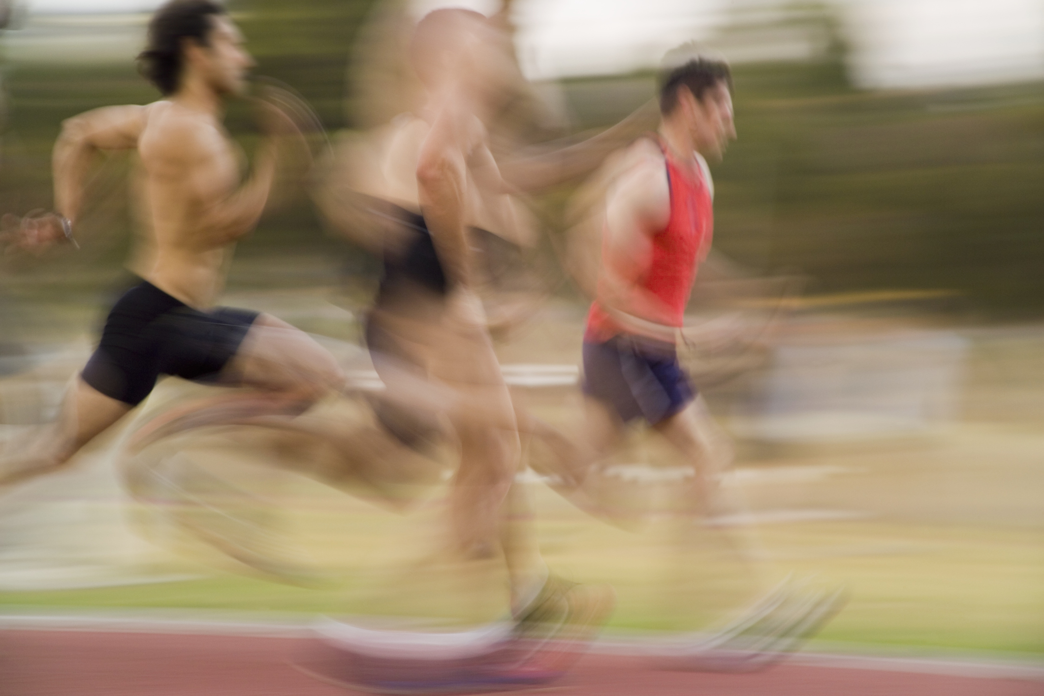 Group of athletes running on a track